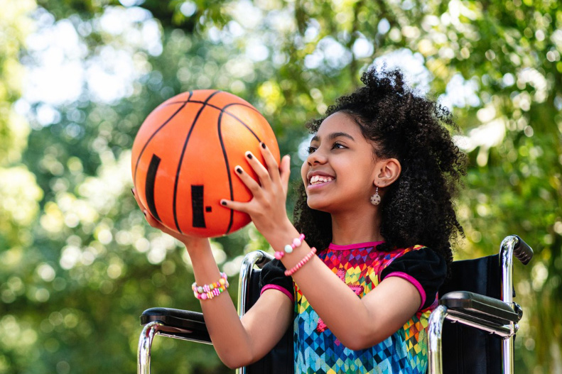girl in wheelchair catching ball