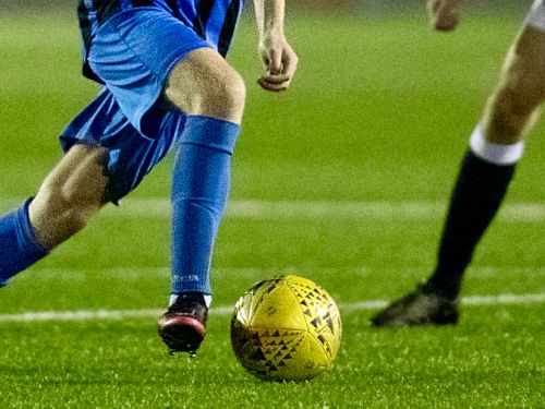 Close up a football player on the ball