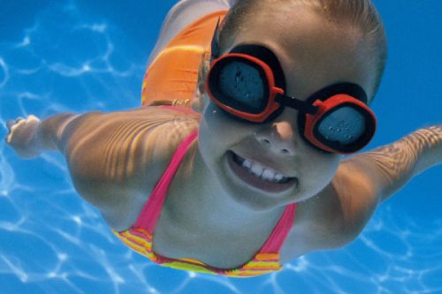 A young girl swimming underwater