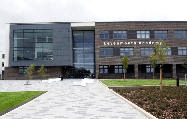 the exterior of Levenmouth Academy, a modern building with a mix of dark brick and large glass windows