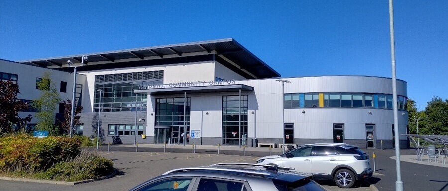 the exterior of Levenmouth Academy, a modern building with a mix of dark brick and large glass windows
